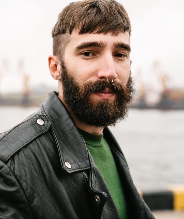 2-photo-closeup-of-bearded-young-man-looking-at-came-UDSWHUP.jpg