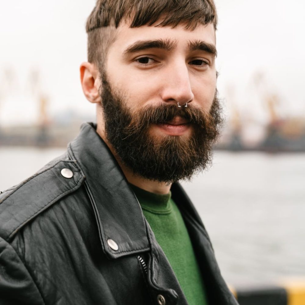 2-photo-closeup-of-bearded-young-man-looking-at-came-UDSWHUP.jpg